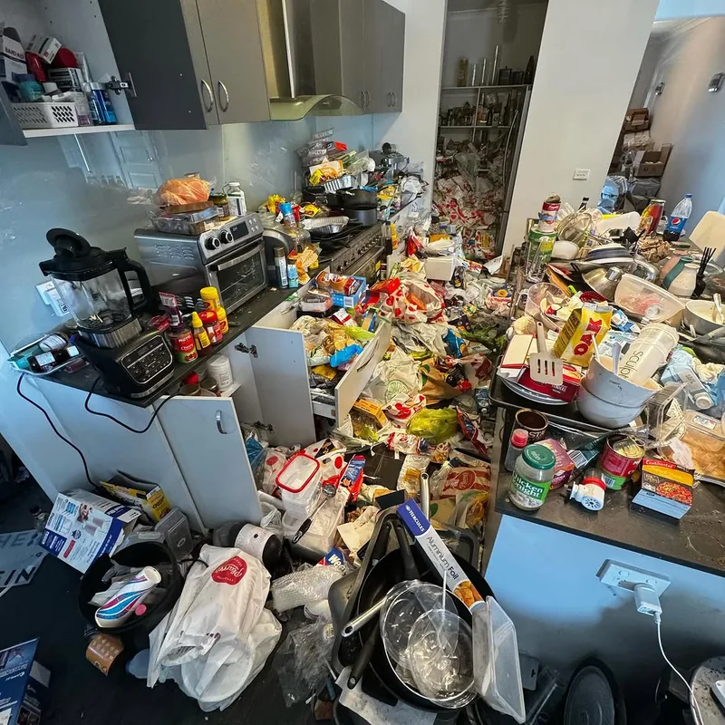 Cluttered kitchen before property clearance and preparation for sale